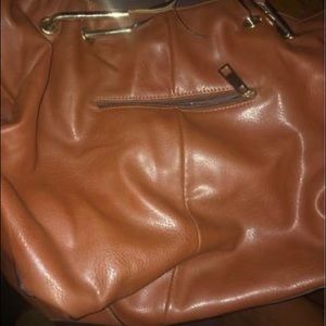 A Michael Kors Woman’s purse with matching men’s Michael Kors jacket.